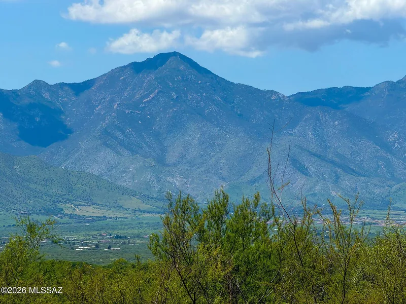 The Huachuca Mountains rising above the valley under a blue sky, seen from the property