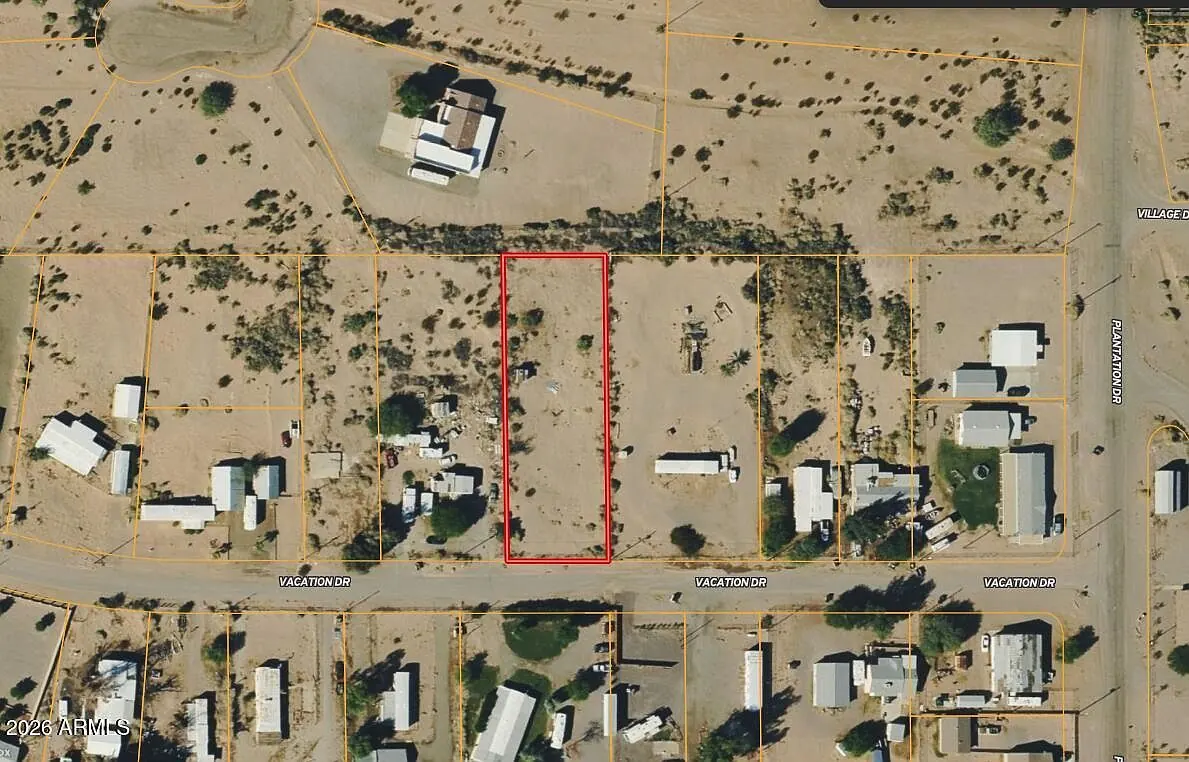 Aerial view of the lot outlined in red in an established neighborhood of homes and mobile homes off Vacation Drive