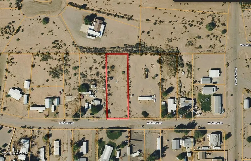 Aerial view of the lot outlined in red in an established neighborhood of homes and mobile homes off Vacation Drive