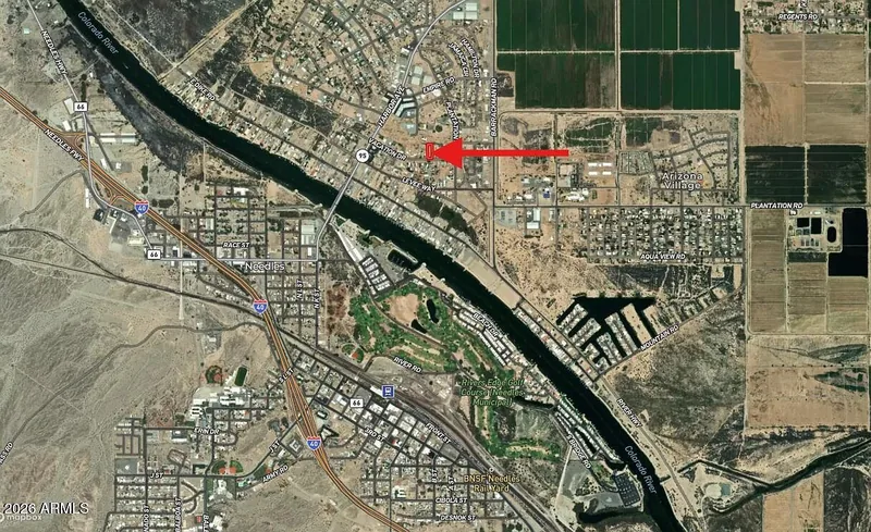 Regional satellite map with a red arrow marking the lot's location east of the Colorado River in Mohave Valley