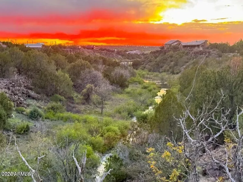 Sunset light over the creek canyon with homes in the distance