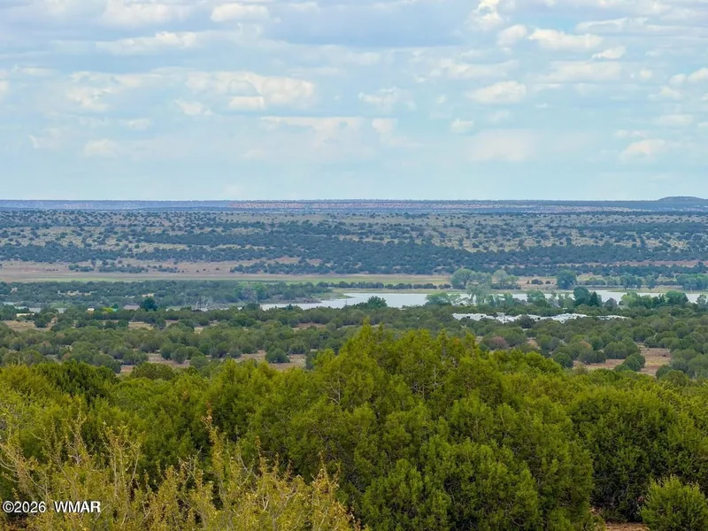 View from the 10 acres over pinyon and juniper toward White Mountain Lake