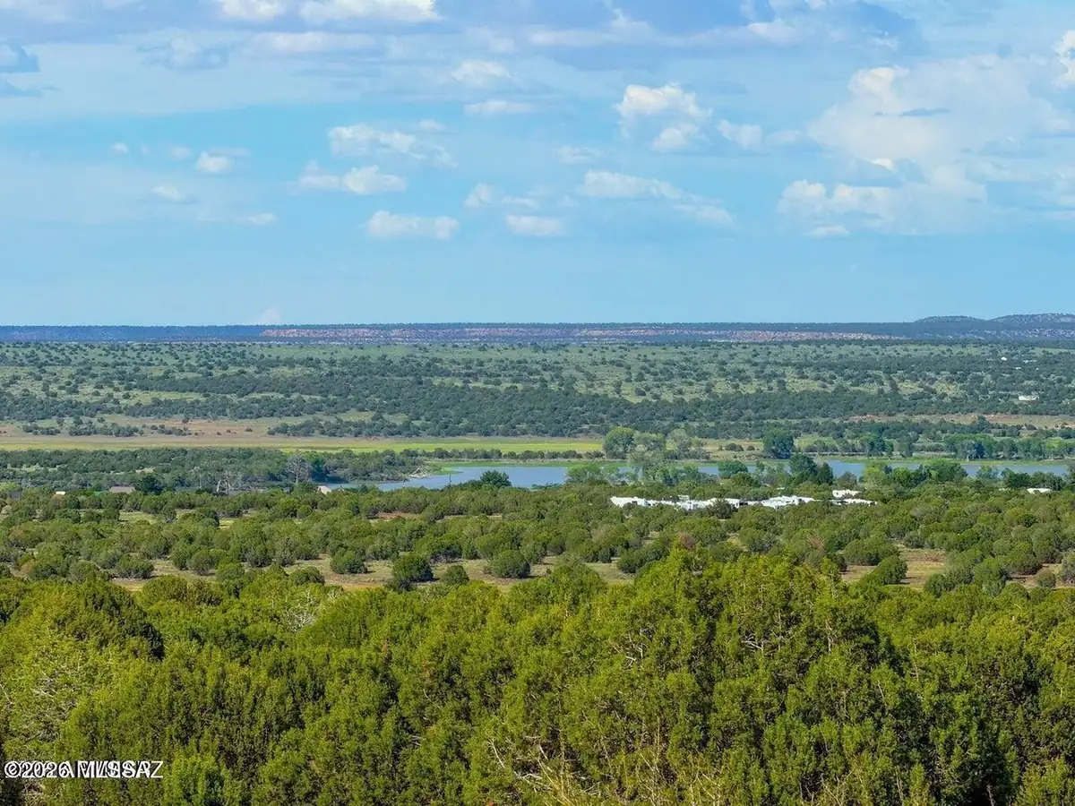 View from the 20 acres over pinyon and juniper toward White Mountain Lake in the distance