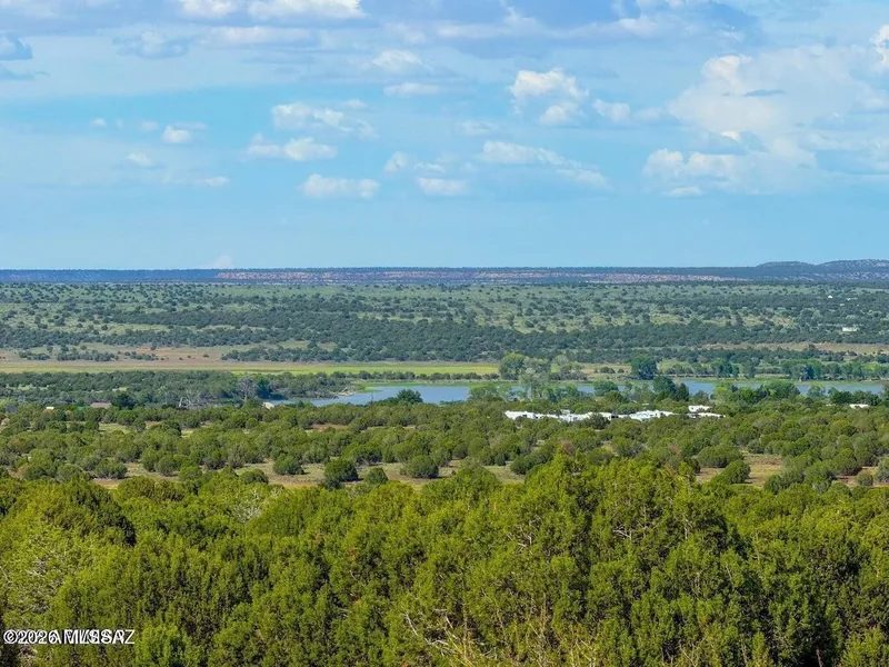 View from the 20 acres over pinyon and juniper toward White Mountain Lake in the distance